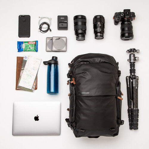 Shimoda Explore V2 25 backpack fitting neatly under an airline seat.
