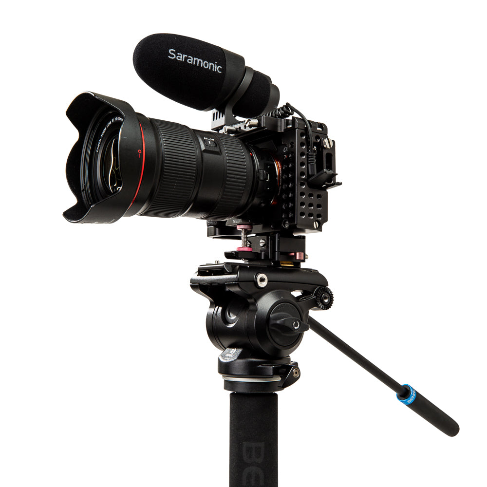 Professional camera setup with lens, microphone, and tripod on a white background