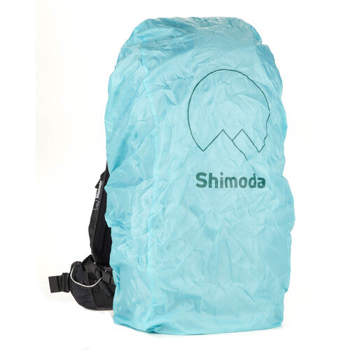 Outdoor Adventure with Action X50 V2 Backpack – A photographer wearing the yellow Shimoda backpack in a rugged outdoor setting, emphasizing its durable and adventure-ready design.