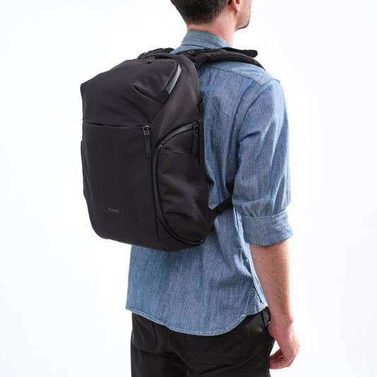 Side view of the Shimoda backpack showing retractable side handle and adjustable straps.