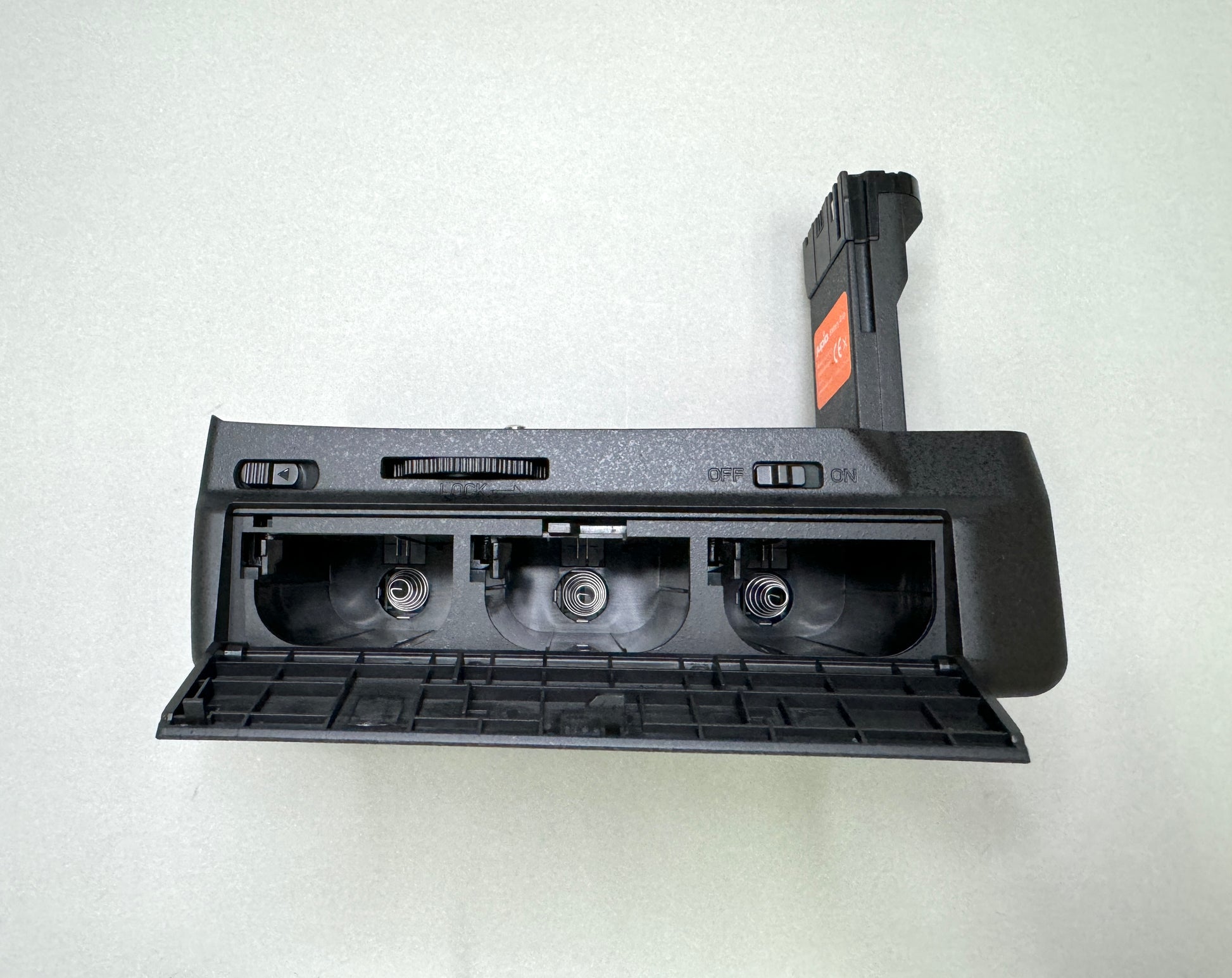 Side profile of the Jupio BMPCC grip highlighting the shutter button, function dial, and AF/AE control buttons.