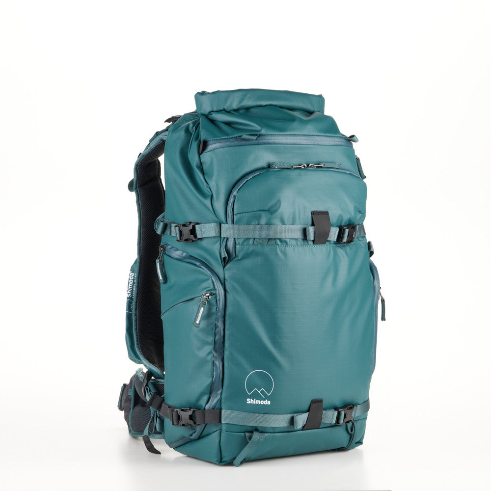 Teal Shimoda Action X30 V2 backpack with removable pouches for tripod or water bottle storage.