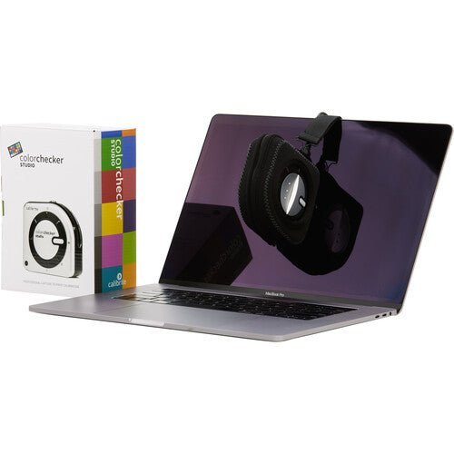 The ColorChecker Classic Mini color reference chart placed next to a camera lens.