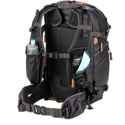 Sleek side profile of the Shimoda V2 25 pack showing its tripod and water bottle pockets.