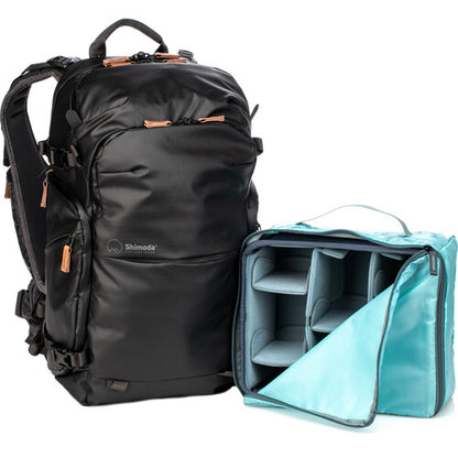 Close-up showing lockable zippers and luggage pass-through on the Shimoda backpack.