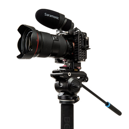 Professional camera setup with lens, microphone, and tripod on a white background