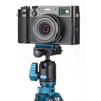 Camera mounted on a blue tripod with a white background