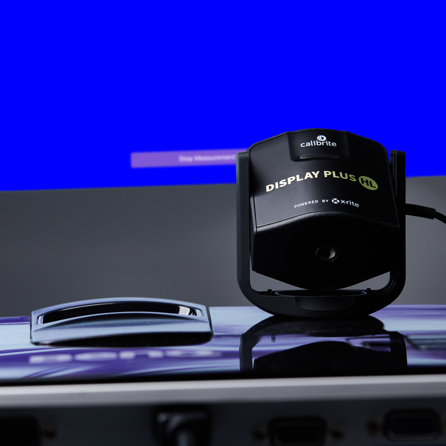 Calibrite Display Plus HL color calibration tool on a desk.