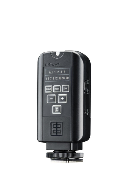 The transmitter in a photographer's hand, showcasing its compact and robust design.