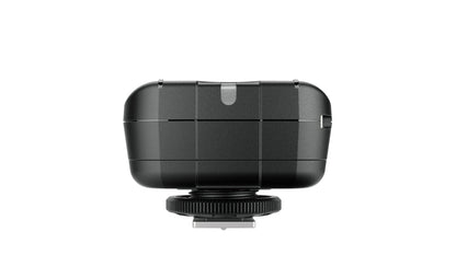 Size comparison of the Elinchrom Skyport Plus transmitter next to a DSLR camera.