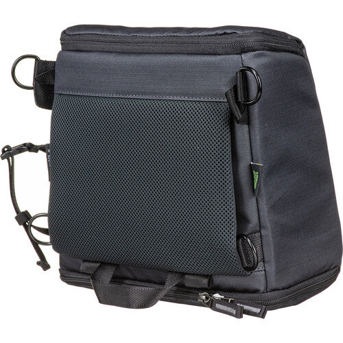 Anthracite Black Shimoda Designs Top Loader being placed inside a large camera backpack.