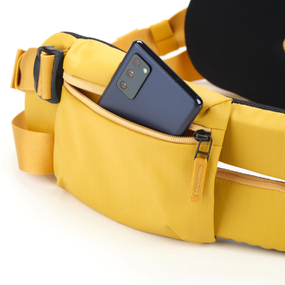 Detailed view of the zip-closure storage pocket on the Shimoda HD Waist Belt holding small a phone.