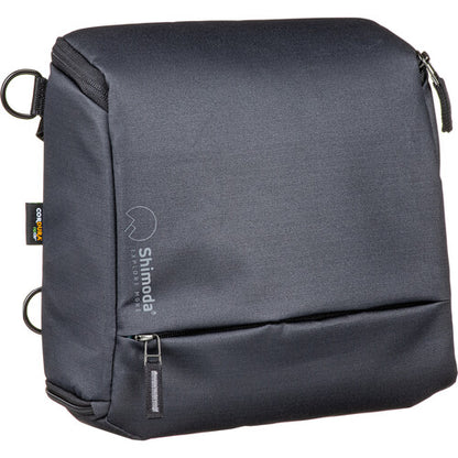 Shimoda Designs Top Loader camera bag holding a DSLR with a 70-200mm lens attached.