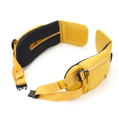 Shimoda HD Waist Belt attached to a loaded camera backpack transferring weight to the hips for hiking.