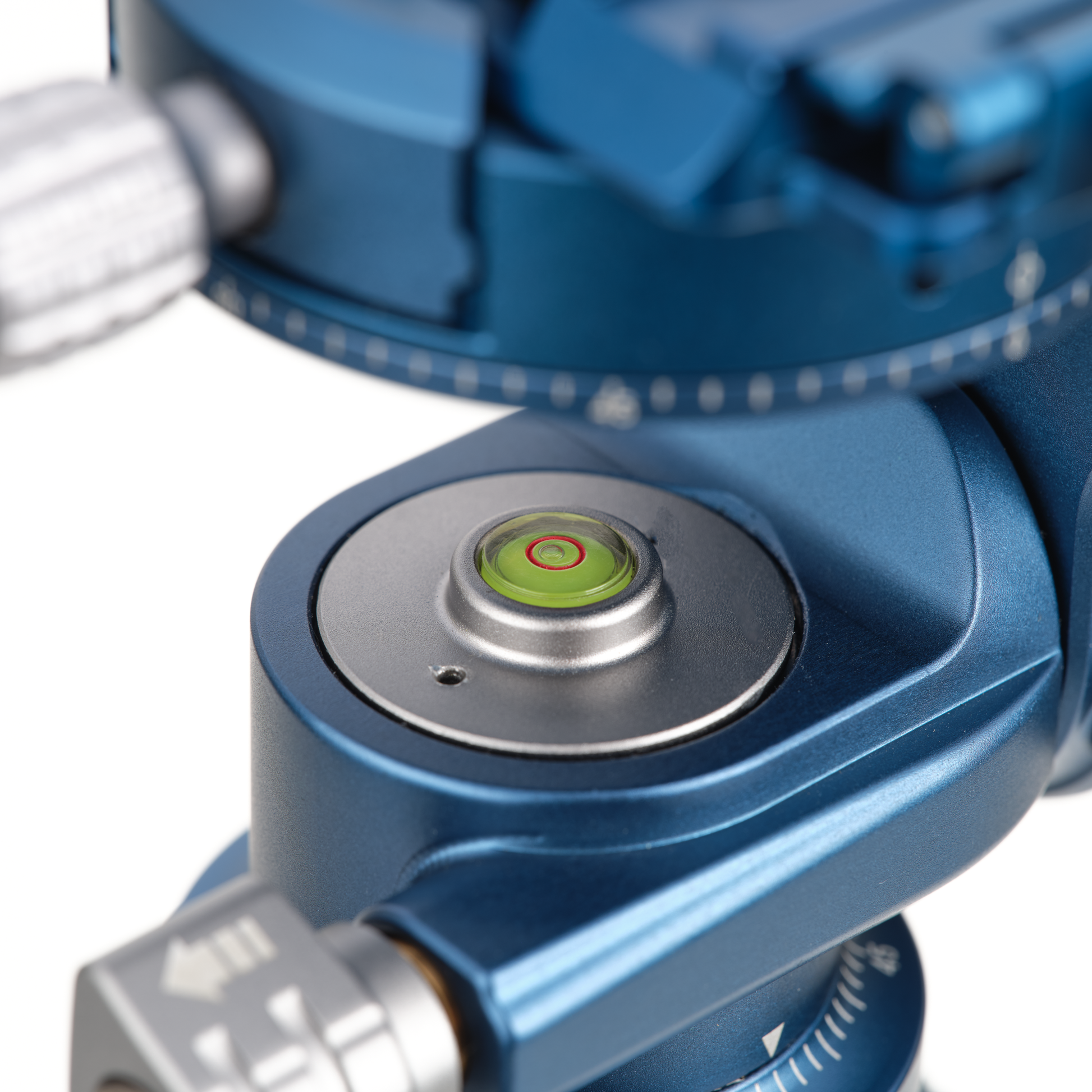 Close-up of a blue mechanical device with a green level indicator.