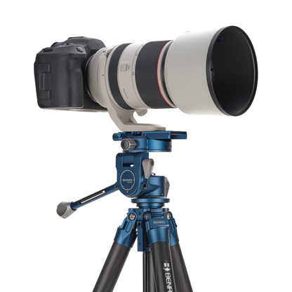 Camera with a large lens on a Benro tripod.