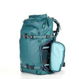 Teal women’s photography backpack with shockproof camera protection, designed for comfort and functionality.