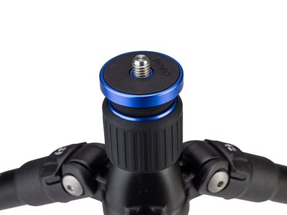 Close-up of a camera tripod head with blue center piece on a white background