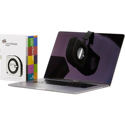 The ColorChecker Classic Mini color reference chart placed next to a camera lens.